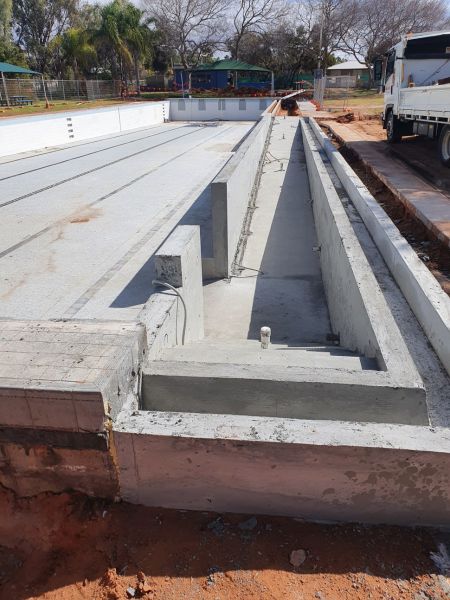 Photograph of the Olympic sized pool showing the completed concreting of the accessibility ramp.
